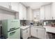 Bright kitchen featuring white cabinetry, stone countertops, gray backsplash, and retro style refrigerator at 5015 Spencer St # C, Las Vegas, NV 89119