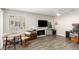 Open concept living room with wood flooring, a fireplace, and lots of natural light at 5015 Spencer St # C, Las Vegas, NV 89119