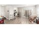 Open-concept living area with wood floors leads to the kitchen and dining area at 5015 Spencer St # C, Las Vegas, NV 89119