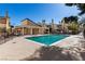 Exterior shot of a clear blue community pool enclosed by black fencing on a bright and sunny day at 5015 Spencer St # C, Las Vegas, NV 89119