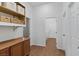 Hallway with wooden cabinets and view into laundry room with washer and dryer at 5265 Lucca Ln, Pahrump, NV 89061