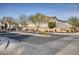 Autumn Winds community entrance featuring street view of homes and landscaping at 5392 Blustery Towns Ave, Las Vegas, NV 89118