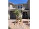 Inviting two-story home featuring a private garage, front yard landscaping, and an arched entryway at 5392 Blustery Towns Ave, Las Vegas, NV 89118