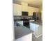 Modern kitchen featuring stainless steel appliances, granite countertops, and white cabinetry at 5392 Blustery Towns Ave, Las Vegas, NV 89118