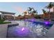 Stunning pool with LED lighting and waterfall feature, surrounded by palm trees and lounge areas at 5865 Alice Landing Ct, Las Vegas, NV 89149