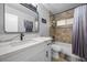 Bathroom featuring a white vanity with modern fixtures and a shower and tub with neutral colored tile at 638 Paloma Dr, Boulder City, NV 89005