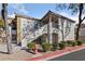 Charming two-story condo featuring textured stucco, concrete tile roof, and manicured landscaping at 6704 Indian Chief Dr # 101, Las Vegas, NV 89130