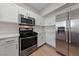 Modern kitchen featuring stainless steel appliances, gas range, and white cabinetry at 6704 Indian Chief Dr # 101, Las Vegas, NV 89130