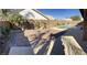 Beautifully landscaped backyard showcasing a sparkling pool, mature trees and a brick patio at 70 Moonlight Village Ln, Henderson, NV 89012