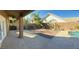 Back patio with a view of the backyard, including the pool, patio, and desert landscaping at 70 Moonlight Village Ln, Henderson, NV 89012