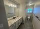Updated bathroom featuring granite countertop, modern vanity, and tiled floor and shower at 70 Moonlight Village Ln, Henderson, NV 89012