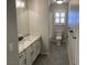 Bright bathroom with granite countertops, a toilet, tile floors, and a shower/tub combo at 70 Moonlight Village Ln, Henderson, NV 89012