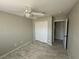 Bedroom featuring tile floors, neutral walls, closet with sliding doors and a ceiling fan at 70 Moonlight Village Ln, Henderson, NV 89012