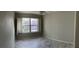 Empty room with a ceiling fan, wood tile floors, neutral colored walls and plantation shutters at 70 Moonlight Village Ln, Henderson, NV 89012
