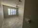 Bedroom with shuttered windows allowing for natural light, with tile flooring and a ceiling fan at 70 Moonlight Village Ln, Henderson, NV 89012