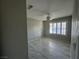 Bright bedroom with tile flooring, shuttered windows, and neutral colored walls at 70 Moonlight Village Ln, Henderson, NV 89012