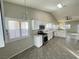 Spacious kitchen with white cabinetry, stainless appliances, and abundant natural light at 70 Moonlight Village Ln, Henderson, NV 89012