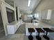 Updated kitchen with island, granite countertops, stainless steel appliances, and a breakfast bar at 70 Moonlight Village Ln, Henderson, NV 89012