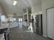 Bright kitchen with granite countertops, stainless steel appliances, white cabinetry, and open to living spaces at 70 Moonlight Village Ln, Henderson, NV 89012