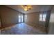 Large main bedroom featuring wood tile flooring, neutral colored walls, and an exit to the backyard at 70 Moonlight Village Ln, Henderson, NV 89012