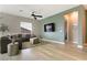 Well-lit living room with modern furnishings, a wall-mounted TV, and an open doorway to the other rooms at 701 Dowland St, Henderson, NV 89011