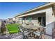 Outdoor patio featuring a dining table, chairs, and artificial grass at 701 Dowland St, Henderson, NV 89011