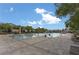 Large community pool surrounded by a spacious deck, lounge chairs, and lush landscaping under a clear blue sky at 701 Dowland St, Henderson, NV 89011