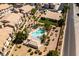 An aerial photograph of a community pool shows relaxation amid lush desert landscaping and well-maintained homes at 7231 Indian Creek Ln # 204, Las Vegas, NV 89149