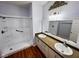 Modern bathroom featuring a double vanity with a large mirror and a spacious walk-in shower at 7231 Indian Creek Ln # 204, Las Vegas, NV 89149