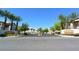 Welcoming entrance to a well-maintained community with palm trees and manicured landscaping at 7231 Indian Creek Ln # 204, Las Vegas, NV 89149