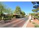 Community entrance featuring a brick-paved road, a gated entry, and lush desert landscaping at 7231 Indian Creek Ln # 204, Las Vegas, NV 89149