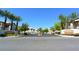 Inviting community entrance with lush palm trees and manicured landscaping offers curb appeal and a warm welcome at 7231 Indian Creek Ln # 204, Las Vegas, NV 89149