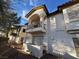 Two-story townhome featuring stucco exterior, a small balcony, and well maintained desert landscaping at 7231 Indian Creek Ln # 204, Las Vegas, NV 89149