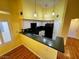 The kitchen features white cabinets and black appliances at 7231 Indian Creek Ln # 204, Las Vegas, NV 89149