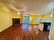Cozy living room featuring laminate floors, ceiling fans, and a brick fireplace at 7231 Indian Creek Ln # 204, Las Vegas, NV 89149