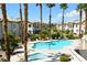 Beautiful community pool area with refreshing water, palm trees, and inviting lounge chairs at 7231 Indian Creek Ln # 204, Las Vegas, NV 89149