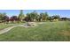 Lush community park with mature trees, manicured lawn and a picnic table at 7735 Sugarloaf Peak St, Las Vegas, NV 89166