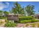 Promenade community sign amidst lush landscaping with blooming flowers and manicured greenery at 7735 Sugarloaf Peak St, Las Vegas, NV 89166