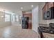 Well-lit kitchen featuring stainless steel appliances, granite countertops, and tile flooring at 7735 Sugarloaf Peak St, Las Vegas, NV 89166