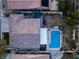 An aerial view of a home showcasing the backyard swimming pool, patio, and lush landscaping at 8220 Flowing Rapids Ct, Las Vegas, NV 89131