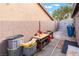 A backyard with a work bench and storage for various items, with block wall and covered portion at 8220 Flowing Rapids Ct, Las Vegas, NV 89131