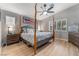 Serene main bedroom with a four poster bed, hardwood floors, plantation shutters, and modern ceiling fan at 8220 Flowing Rapids Ct, Las Vegas, NV 89131