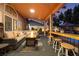 Stylish covered patio with comfortable seating, fire pit, and bar area at 8220 Flowing Rapids Ct, Las Vegas, NV 89131