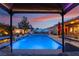 Backyard pool featuring a lounge seating, in-ground pool, patio furniture, water feature, and vibrant plants at 8220 Flowing Rapids Ct, Las Vegas, NV 89131