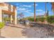 Spacious outdoor patio with a dining set, plush seating, lush greenery, and a private pool for entertainment at 8225 Taos Paseo Ave, Las Vegas, NV 89128