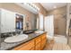 Elegant bathroom with a double sink vanity, shower over tub, and plenty of counter space at 8225 Taos Paseo Ave, Las Vegas, NV 89128