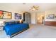 Comfortable bedroom with blue bedspread, ceiling fan, and artwork on the wall at 8225 Taos Paseo Ave, Las Vegas, NV 89128