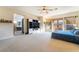 Inviting bedroom features balcony access, plush carpeting, and entertainment center at 8225 Taos Paseo Ave, Las Vegas, NV 89128