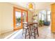 Cozy breakfast nook features wood table and chairs and natural light from french doors at 8225 Taos Paseo Ave, Las Vegas, NV 89128