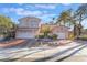 Charming two-story home featuring a well-maintained yard, a tile roof, and a two-car garage at 8225 Taos Paseo Ave, Las Vegas, NV 89128